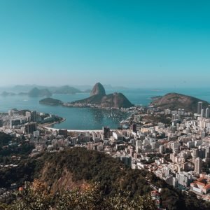 A landscape of Rio De Janeiro surrounded by the sea under a blue sky in Brazil